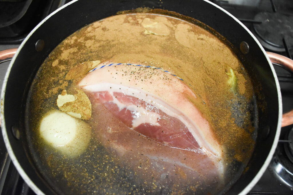 Ham gammon in pot with water and seasonings