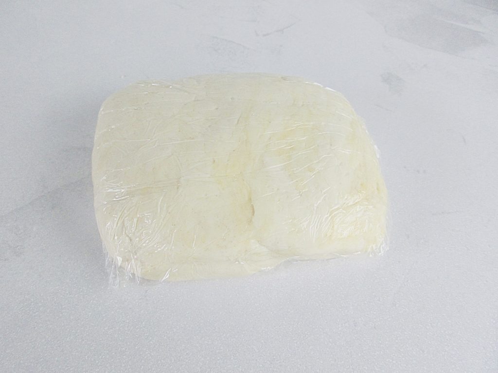 Puff pastry dough wrapped in clingfilm