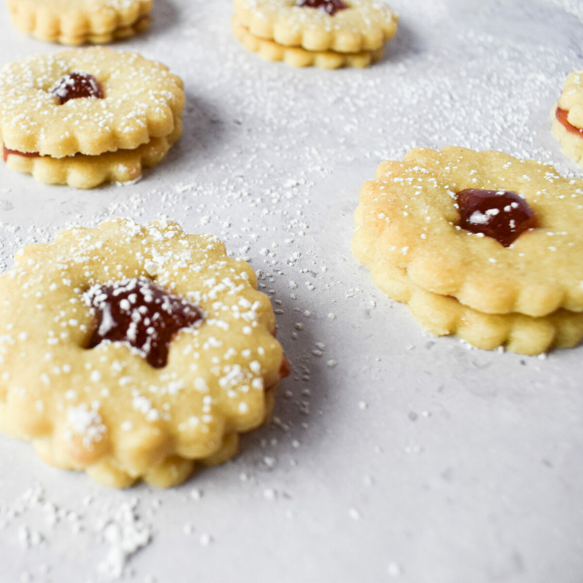 Prosecco jam sandwich biscuits with icing sugar