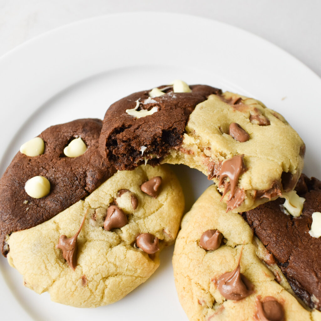 3 chocolate chip swirl cookies on a plate.