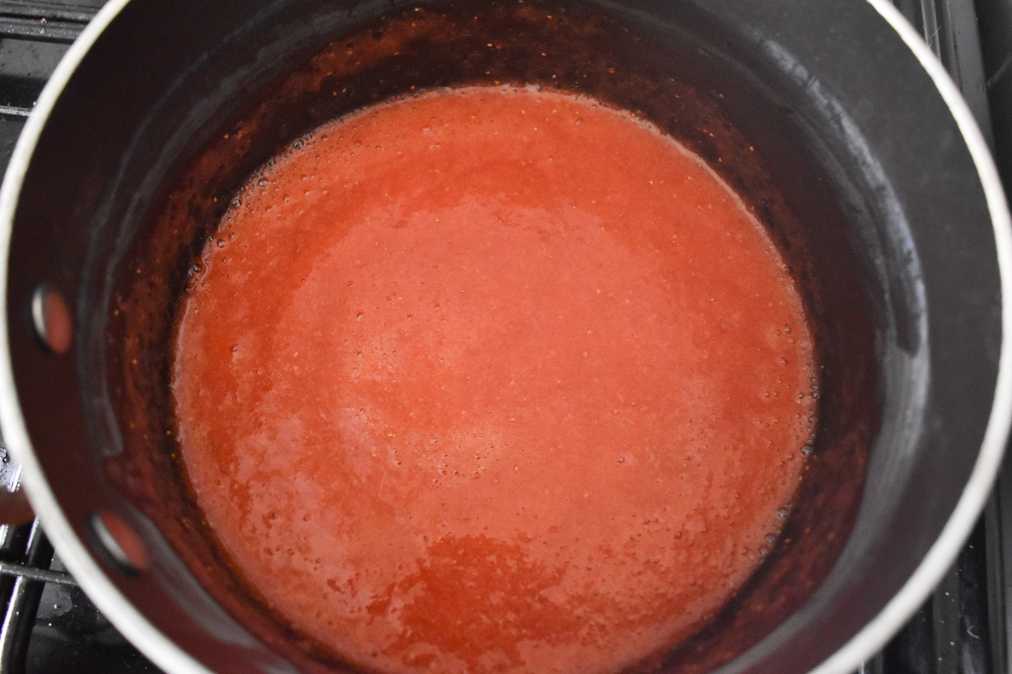 Pureed strawberries in a saucepan.
