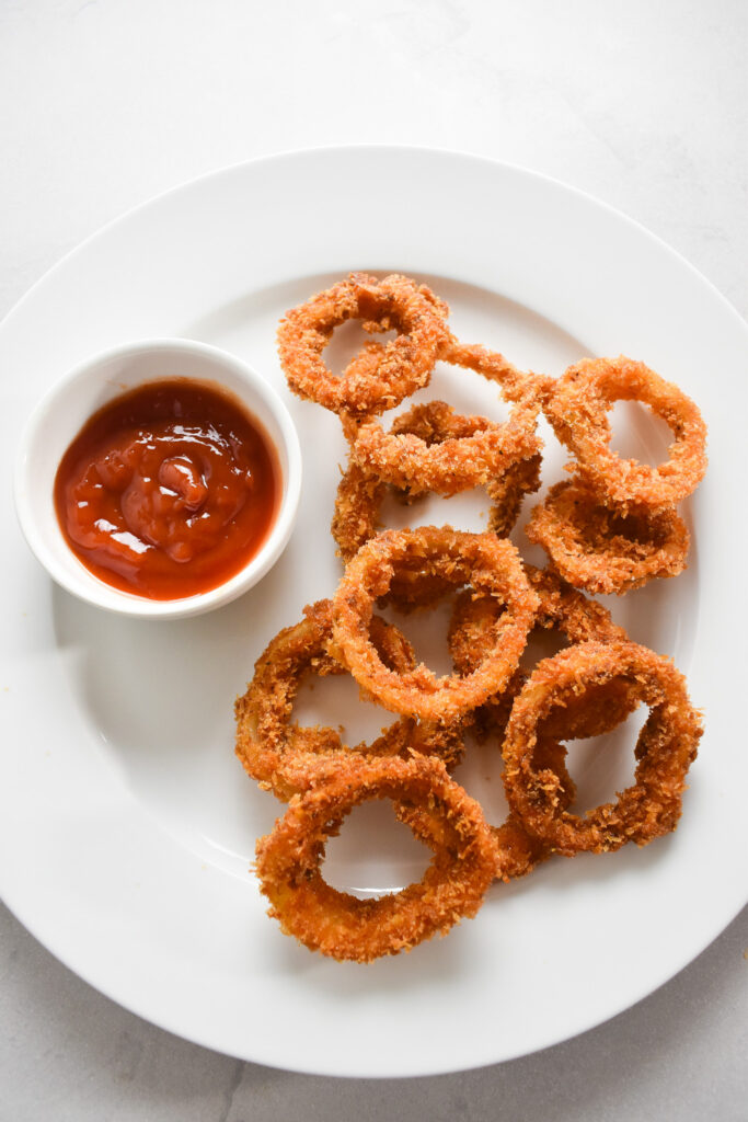 Crispy onion rings on plate