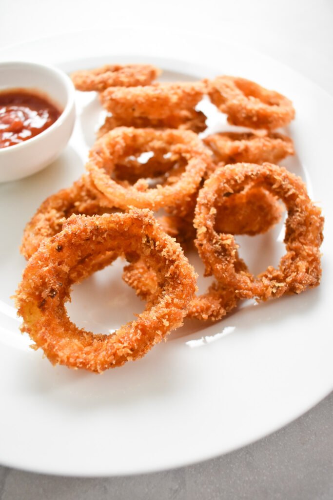 Crispy onion rings on plate