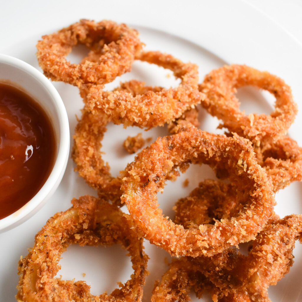 Crispy onion rings on plate