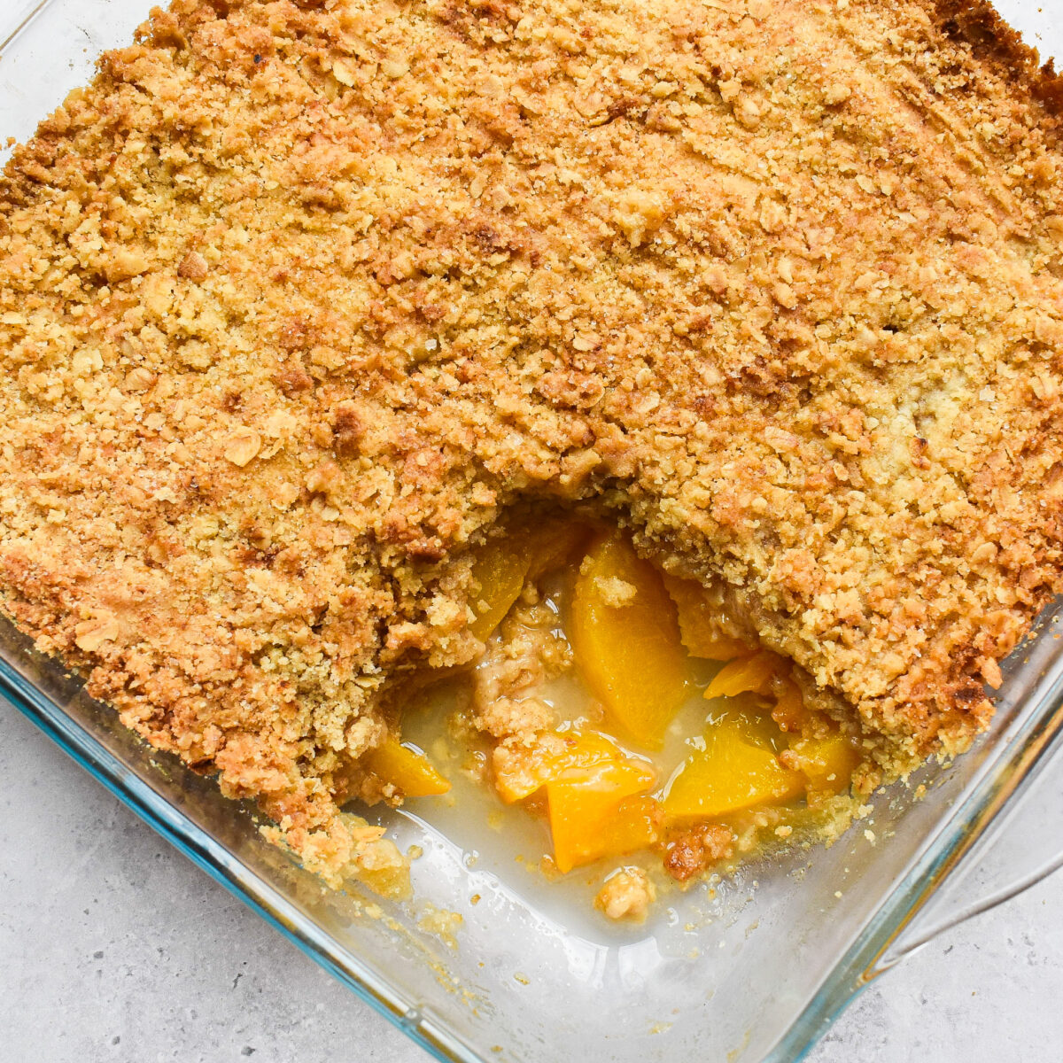 Peach crumble with a piece taken