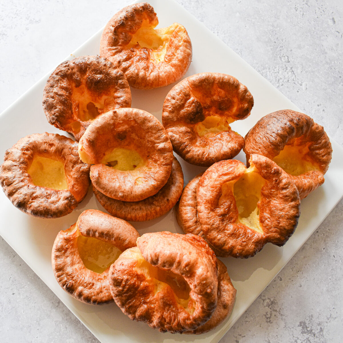 yorkshire puddings on white plate.